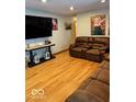 Spacious living room with hardwood floors and comfortable brown leather furniture at 1733 N Buck Creek Rd, Greenfield, IN 46140