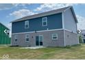 Two-story home's rear view, featuring gray siding and a brick base at 251 Dyson Dr, Whiteland, IN 46184