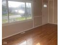 Bright living room with hardwood floors and large windows at 2610 W 18Th St, Anderson, IN 46011