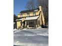 Snow covered yard and charming yellow house at 2615 Baltimore Ave, Indianapolis, IN 46218