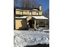 Yellow house exterior with snow on ground at 2615 Baltimore Ave, Indianapolis, IN 46218