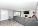 Spacious living room with gray sectional sofa and fireplace at 3375 Lincoln Rd, Indianapolis, IN 46222