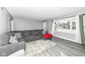 Living room with gray sectional sofa and wood-look floors at 3375 Lincoln Rd, Indianapolis, IN 46222