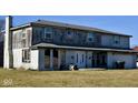 Two-story house in need of significant repair, with a large yard at 4349 Alhambra Dr, Anderson, IN 46013