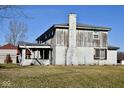 Back of a fixer-upper home with a damaged porch and chimney at 4349 Alhambra Dr, Anderson, IN 46013