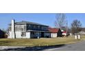 Two-story house requiring renovations, situated on a grassy lot at 4349 Alhambra Dr, Anderson, IN 46013