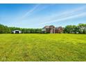 Large, verdant lawn surrounding this two-story home provides ample outdoor space and privacy at 4450 W 300 N, Fairland, IN 46126