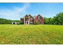 A beautiful brick house with a sprawling green lawn offers a picturesque suburban living experience at 4450 W 300 N, Fairland, IN 46126