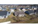 Aerial view of a neighborhood with houses and a pond at 4667 W Meadows Ln, New Palestine, IN 46163