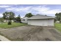 Single car garage with white siding and asphalt driveway at 5201 N White Ln, Lawrence, IN 46226
