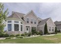 Two-story brick home with landscaped yard and large windows at 5739 Bentbrook Dr, Bargersville, IN 46106
