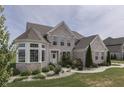 Two-story brick home with landscaped yard and large windows at 5739 Bentbrook Dr, Bargersville, IN 46106