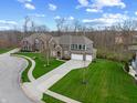 A suburban neighborhood featuring a home with a manicured lawn and a spacious driveway at 6711 Colville Pl, Indianapolis, IN 46236