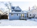 Backyard view of the house with a deck and snowy ground at 857 S Tompkins St, Shelbyville, IN 46176