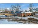 Home exterior showcasing deck and snowy yard at 8810 W Tulip Tree Dr, Muncie, IN 47304
