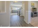 Welcoming foyer with sleek wood floors, staircase, and an open view into the living area at 1001 Parker Ln, Westfield, IN 46074