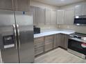 Updated kitchen with stainless steel appliances and light wood cabinets at 117 Tracy Rd, Whiteland, IN 46184