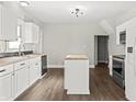 Modern kitchen with white cabinets and butcher block island at 1218 N Grant Ave, Indianapolis, IN 46201