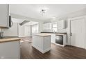 Open concept kitchen with white cabinets and kitchen island at 1218 N Grant Ave, Indianapolis, IN 46201