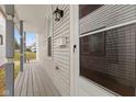 Front porch with gray siding and a wooden floor at 128 Wisconsin St, Indianapolis, IN 46225