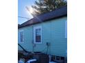 Side view of the house, showcasing the light green siding at 135 S 11Th Ave, Beech Grove, IN 46107