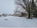 Cozy ranch home with a snowy yard and outbuildings at 1545 S Us 421, Zionsville, IN 46077