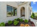 Charming brick archway and a front entry with manicured landscaping at 15844 Nocturne Dr, Westfield, IN 46074