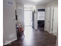 Spacious entryway with wood-look floors, bench, and access to other rooms at 173 Megan Way, Cumberland, IN 46229