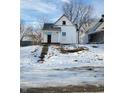 White house with front porch and snowy yard at 1826 Tallman Ave, Indianapolis, IN 46218