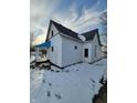 Rear view of a white house with snowy yard at 1826 Tallman Ave, Indianapolis, IN 46218