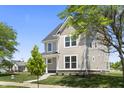 Two-story home with mature trees, gray siding, a dark roof, and a covered front porch at 1833 Luther St, Indianapolis, IN 46203