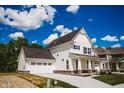 Stunning two-story home with a spacious driveway and attached garage, blending modern design with curb appeal at 1841 Luther St, Indianapolis, IN 46203
