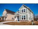 A lovely two story home with beautiful landscaping. The home is green with white trim at 1902 Zwingley St, Indianapolis, IN 46203