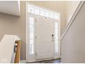 Bright entryway with a white door, sidelights, and staircase leading to upper floors at 2010 Rhettsbury St, Carmel, IN 46032