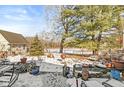 Backyard with snowy deck, grill, and wooded views at 2230 E 75Th St, Indianapolis, IN 46240