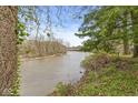 Picturesque river view highlighting lush greenery and a bridge in the distance, emphasizing the tranquil setting at 2230 E 75Th St, Indianapolis, IN 46240
