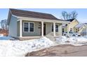 Charming craftsman style home with a front porch and snowy landscape at 241 Cleveland St, Columbus, IN 47201