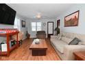 Living room with hardwood floors, large TV and comfy couch at 2515 Fairfax Rd, Indianapolis, IN 46227