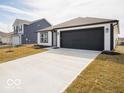 A modern home featuring clean white siding, black trim, and a spacious driveway at 3201 W Keepsake Ln, Monrovia, IN 46157