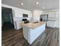 Gourmet kitchen with stainless steel appliances, island, and quartz counters at 3201 W Keepsake Ln, Monrovia, IN 46157