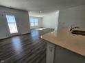 Open-concept living area with vinyl floors extends from a modern kitchen at 3201 W Keepsake Ln, Monrovia, IN 46157