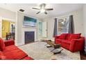 Living room with red couches, fireplace, and hardwood floors at 4702 Michigan Rd, Indianapolis, IN 46228