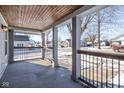 Inviting front porch with wooden ceiling, railings, and views of the neighborhood at 4759 Ohio St, Clayton, IN 46118