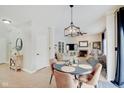 Bright dining area with a round table and four chairs, adjacent to the living room at 5230 Berkshire South Blvd, Greenwood, IN 46142