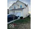 Side view of a two-story house with attached garage and driveway at 6628 Heben Ct, Indianapolis, IN 46113