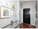Inviting entryway with dark wood floors and decorative artwork leading into the home at 7129 Dublin Ln, Indianapolis, IN 46239