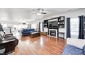 Spacious living room with hardwood floors, a fireplace, and abundant natural light at 7129 Dublin Ln, Indianapolis, IN 46239