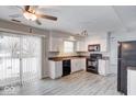 Eat-in kitchen with white cabinets, granite counters, and gray flooring at 7824 Rosebush Dr, Indianapolis, IN 46237