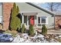 Inviting front entrance with red door and landscaping at 8176 Foxchase Cir, Indianapolis, IN 46256