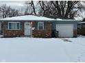 Brick ranch home with attached garage, snowy front yard at 835 E Berwyn St, Indianapolis, IN 46203